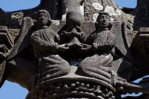 Two angels have collected Jesus' blood in a chalice. Part of the Lampaul-Guimiliau calvary