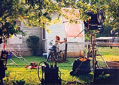 Laura Leighton sets up the bottles to be shot down while filming "In the Name of Love: A Texas Tragedy"