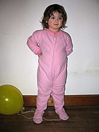Toddler in footed pajamas.