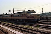 Diesel train in rail siding near station