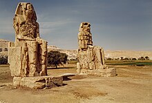 Photo shows the two statues known as The Colossi of Memnon. The massive statues are made from blocks of quartzite quarried from Gabel el Ahmar.