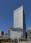 Ground-level view of a glass, rectangular high-rise