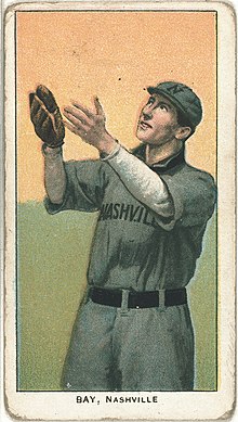 An illustration of a man in a gray baseball uniform, hands extended, prepared to catch a falling ball.