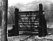 Park sign reading: "Lewis Mountain – Negro Area – Coffee Shop & Cottages - Campground Picnicground – Entrance"