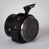 Sony Alpha ILCE-QX1 APS-C-frame camera with body cap flash extended