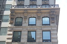 Detail of the fifth and sixth stories of the Knox Building, as seen on Fifth Avenue. The cornice above the sixth floor is carried by brackets