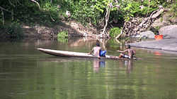 Boys in a canoe on the Gran Rio river