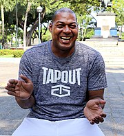 Soccer player Eduardo Hurtado sitting in a courtyard while laughing