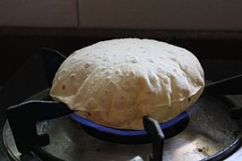 Chapatis are cooked on open-flame once partly cooked on tava, which fluffs it