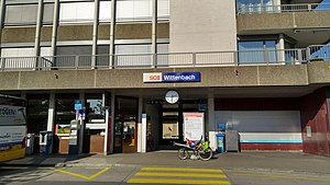 Station with flat-roofed one story entrance and office space above