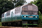 Green colored train running on line, with "Mount Lake Onuma" on plate