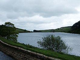 A reservoir surrounded by fields and trees