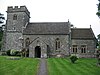 Stone building with square tower.