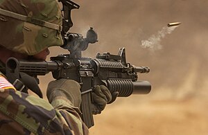M4 Carbine with an ejected ammunition casing in mid-air