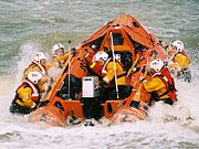 The inshore D-class lifeboat Spirit of Berkhamsted (D-607) being launched through the surf of the Happisburgh coast.