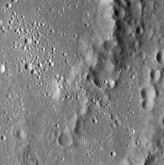 The southeastern peak ring has a lower albedo than the rest of the crater, and there are possible hollows on the peaks.