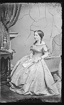 Portrait of Myra Clark Gaines seated, looking away from camera.