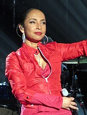 A dark-skinned woman wearing a red leather jacket