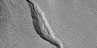 Close view of channel in gully showing streamlined forms, as seen by HiRISE under HiWish program