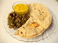 Plain dal served with roti, sauteed okra and green-mango pickle.