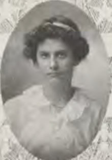 A young white woman with dark curls, in an oval frame