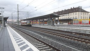 Red-and-white railcar at island platform