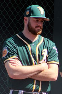 A baseball player in dark green
