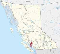 A map of British Columbia depicting its 29 regional districts and equivalent municipalities. One is highlighted in red.