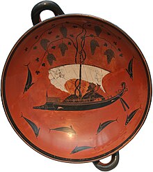A Greek wine-cup, with two handles: in the centre of the bowl, Dionysus sits on a ship, surrounded by dolphins in the sea