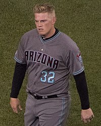 A man in a gray baseball uniform with "Arizona" on the chest in black