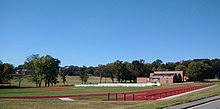 oval track with five lanes, baseball diamond, soccer field, and gymnasium