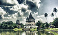 Image 48The pictured Shiva Temple is situated in Puthia Bazar of Rajshahi District. It was built on a hing plinth on the southern bank of a large tank. The temple is a 19.81 meter square building and total height is 35.03 meter. It is a Pancha Ratna type building consists of a Garbhagriha and a surrounding verandah. Rani Bhubanmoye Debi built this temple in 1823 AD. Photo Credit: Nasir Khan Saikat