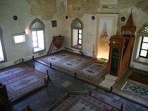 Another view of the prayer hall, with prayer rugs. The small wooden structure near the corner is a kürsü or loge for delivering lectures other than Friday sermons at the minbar, and is typical of Turkish mosques