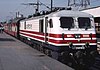 An Indian Railways WAP-5 locomotive and passenger train