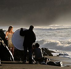 Photographing a model. An assistant is holding a reflector.