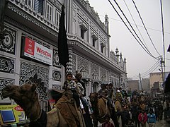 Muharram procession in India, with an azakhana in the background