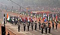Indian Army bands marching behind an ASEAN flag bearer contingent through the Rajpath