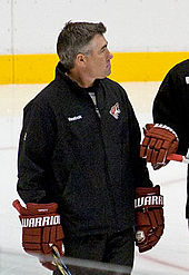 Tippett on the ice wearing a pullover