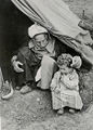 Old and young in the entrance of a tent, 1948
