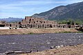 Taos Pueblo, a World Heritage Site, belonging to a Native American tribe of Pueblo people, marking cultural development during the Pre-Columbian era.