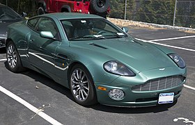 A photo of a dark green 2002 Vanquish, parked in a parking lot.