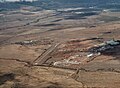 Aerial view, from the south, of Puʻunēnē with the old airstrip that is now the dragstrip at Maui Raceway Park