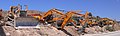Caterpillar D9L bulldozer, excavators and other heavy equipment vehicles parked near a quarry in Israel
