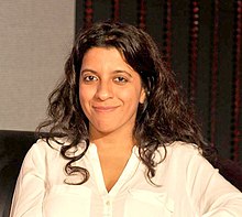 A photograph of Zoya Akhtar smiling, looking towards the camera