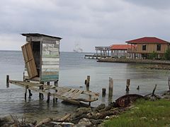 The outhouse over the water stands on the bay.