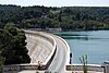 A structure coated with marble impounds a reservoir.