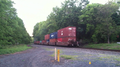 Norfolk Southern westbound train on the Lehigh Line passing through a crossing near Flemington, New Jersey, Picture 3- in back of train part one