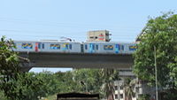 A metro train on an elevated viaduct
