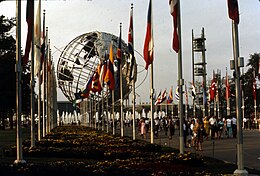 View of the Unisphere, a steel structure depicting the Earth; there are world flags in the foreground