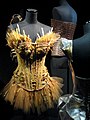 A bustier-style dress made of grass that is woven to resemble feathers